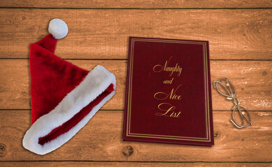 Santa's hat , naughty and nice list and eyeglasses on a wooden table closeup
