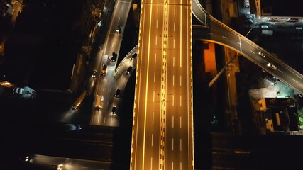 Closeup traffic road with cars, trucks drive at night top down aerial view. Philippines capital...