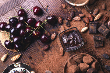 art background with healthy delicious dark truffles, chocolate  and  ingridients:  natural cocoa...