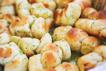 A view of a background of garlic knots drenched in olive oil.