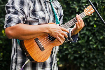 latin musician playing a guitar at the street in Mexico city