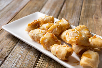A view of a dessert plate of Thai deep fried banana coins.