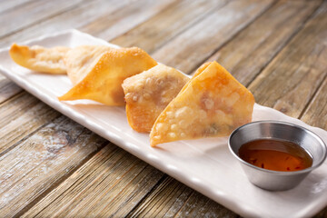 A view of an appetizer plate of deep fried wontons.