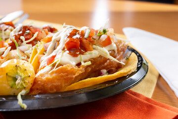 A closeup view of a plate of fish tacos.