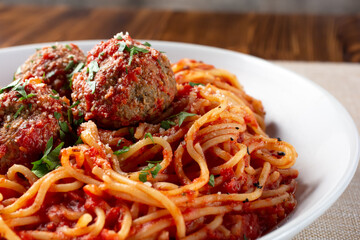 A closeup view of a bowl of spaghetti and meatballs.
