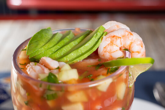 A closeup view of a Mexican style shrimp cocktail.
