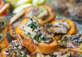 Sandwiches with sprats and cucumber on croutons.Homemade sandwiches on the kitchen table.