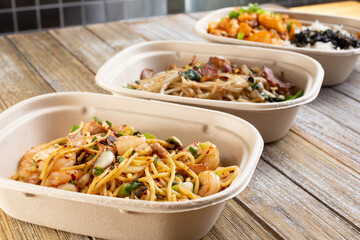 A view of several fast casual pan Asian noodle and rice bowls.