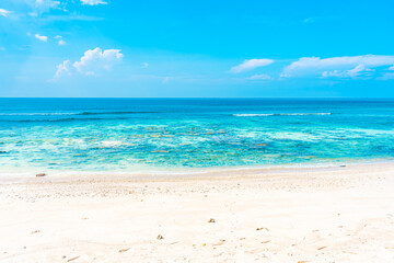 Fototapeta na wymiar Beautiful tropical empty beach sea ocean with white cloud on blue sky