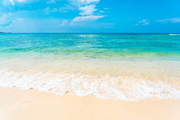 Beautiful tropical empty beach sea ocean with white cloud on blue sky