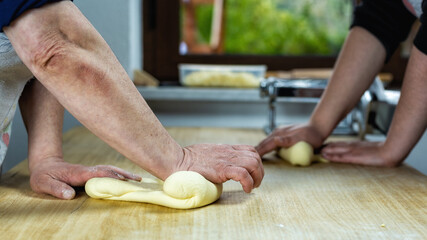 Close-up of woman's hands working the dough to prepare cheese ravioli. Traditional Sardinian...