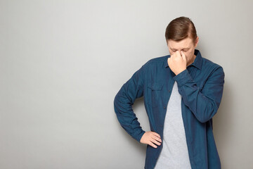 Portrait of thoughtful tired mature man touching bridge of his nose