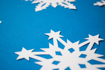 Close up paper white snowflake on blue background