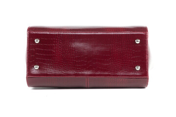 Naklejka premium red stylish ladies leather bag on a white background, bottom view