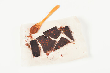 Broken bar homemade dark chocolate with spoonful