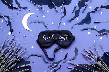 Sleep mask with lavender on dark blue color background with black clouds, Moon and stars. Text Good...