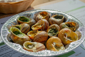 Snails with different sauces on a plate. French cuisine. Snails delicates  © KoT photo