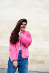 young cute girl teenager in pink fur coat gesturing hanging around outdoor , lifestyle people concept