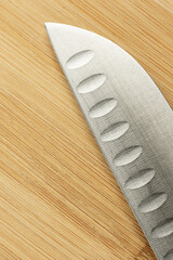 Blade of a knife on wood