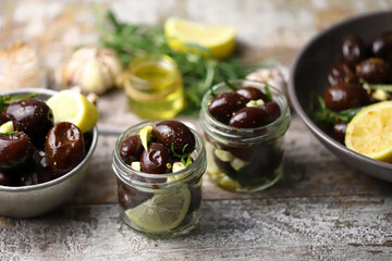 Selective focus. Pickled plums in a bowl and jars. Plums with garlic and rosemary. Fermentation of plums. Gourmet appetizer soaked plums.