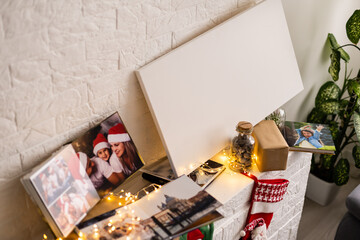 Naklejka na ściany i meble Christmas gifts, photo canvas on the fireplace