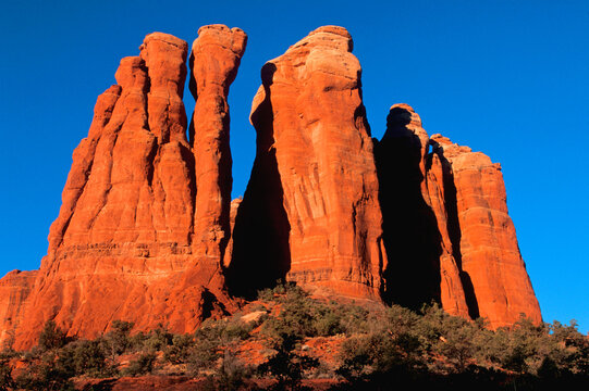 Cathedral Rock Spires Close-Up at Sunrise in Sedona Arizona USA.  The Early morning sun adds even more color to the red rocks.