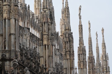 Fototapeta na wymiar Spectacular pinnacles and Gothic sculptures from Milan Cathedral, Italy