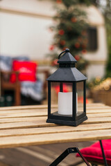 Christmas decorations. Street lamp with candle on the table. outdoor. Decoration Xmas and holiday