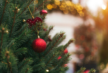 Outdoors image of beautiful decorated christmas tree. Christmas tree branches with balls, christmas tree toy and festive lights with sparkles. Christmas decoration. Copy space.