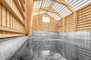 Large engineering hall in timber construction with a concrete base wall and reflection of the...