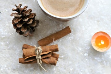 Obraz na płótnie Canvas Coffee with cinnamon and winter background