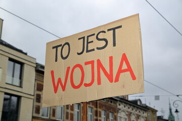 banner with slogan IT'S A WAR in Polish language  in black and red during anti-government demonstration organized by Women Strike in Poland