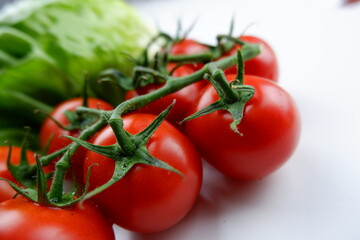 tomatoes on vine with lettuce 