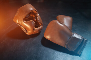 top view of boxing gloves and protective helmet on black background