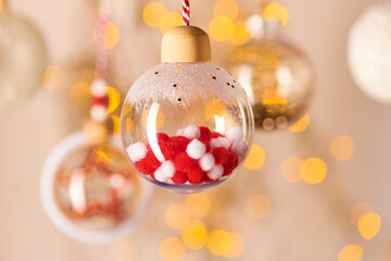 Decorative ball with white and red decorations inside hanging in front of camera