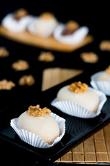 Cameo dessert. Cameos with nuts on top. Sweet cameo on the table.