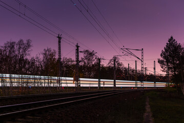 Fototapeta premium Light trails from a train, railroad tracks at night, Light Trails, Train, abstract, colorful