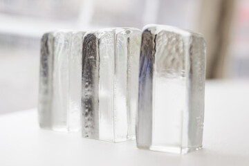 Three transparent glass cubes with reflection.