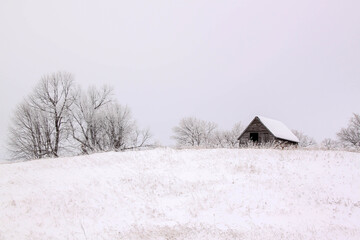 Small building on a hill on a frosty day in rural Minnesota, USA.
