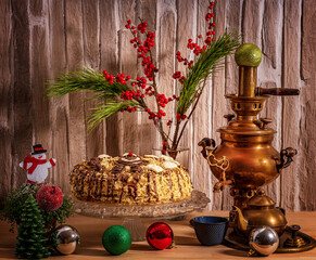 Homemade cake on a crystal dish, and Christmas decorations and flowers on the table.