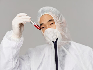 man laboratory clothes research analyzes vaccine gray background