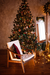 Christmas and New year decorate the interior of the room with a Christmas tree. Happy New year and merry Christmas. The room where the garlands are lit