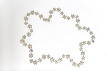 Christmas frame made of snowflakes on a white background