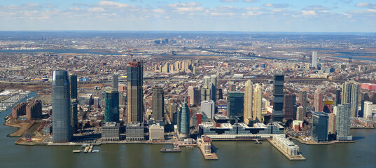 Jersey City modern skyscrapers skyline including from New York Harbor near New York City NYC, New Jersey NJ, USA.