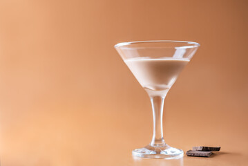 Chocolate cocktail in a glass on a brown background