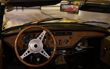 Detail of a vintage dashboard of a convertible sports car from the 60s