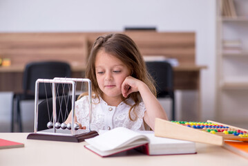 Small girl preparing for exams at home