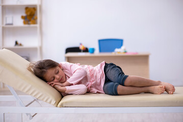 Small girl waiting for doctor in the clinic