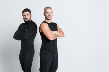 two athletic personal fitness trainers or bodybuilders on white background