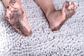 dirty kid feet on a fluffy mat.daily life dirty stain for wash and clean concept